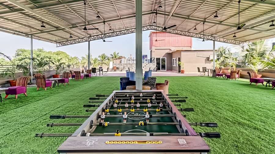  A foosball table positioned in the deck area, surrounded by multiple sofas