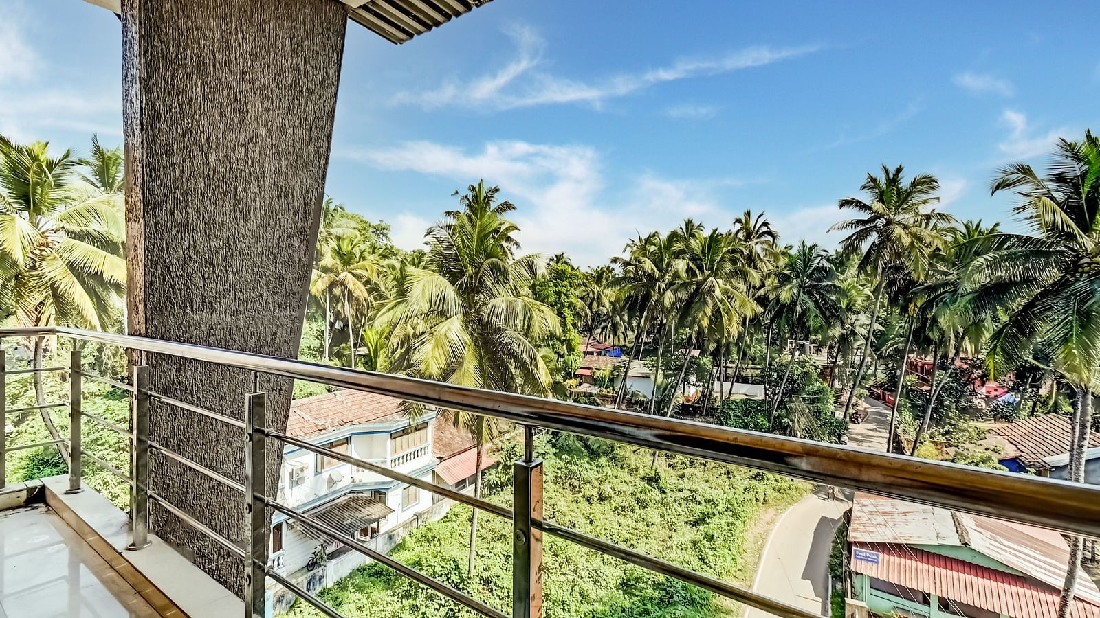 Balcony offering a delightful view of the lush, green coconut trees