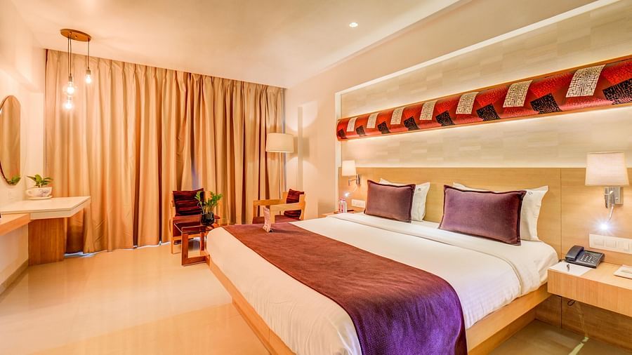 view of Premium rooms with king sized bed, curtains and lavish interiors at The SSK Solitaire Hotel & Banquets, Mumbai Naka - Nashik