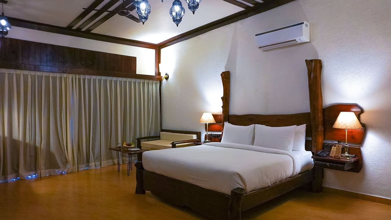 bedroom with white bed covers and other various other amenities at Jagira Ananta Elite 2