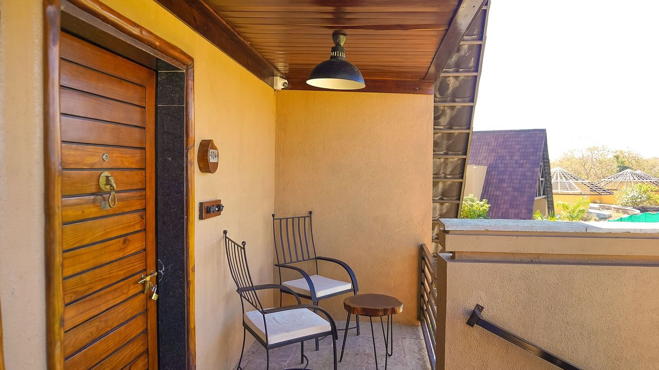 balcony with chairs and a small table at Jagira Ananta Elite
