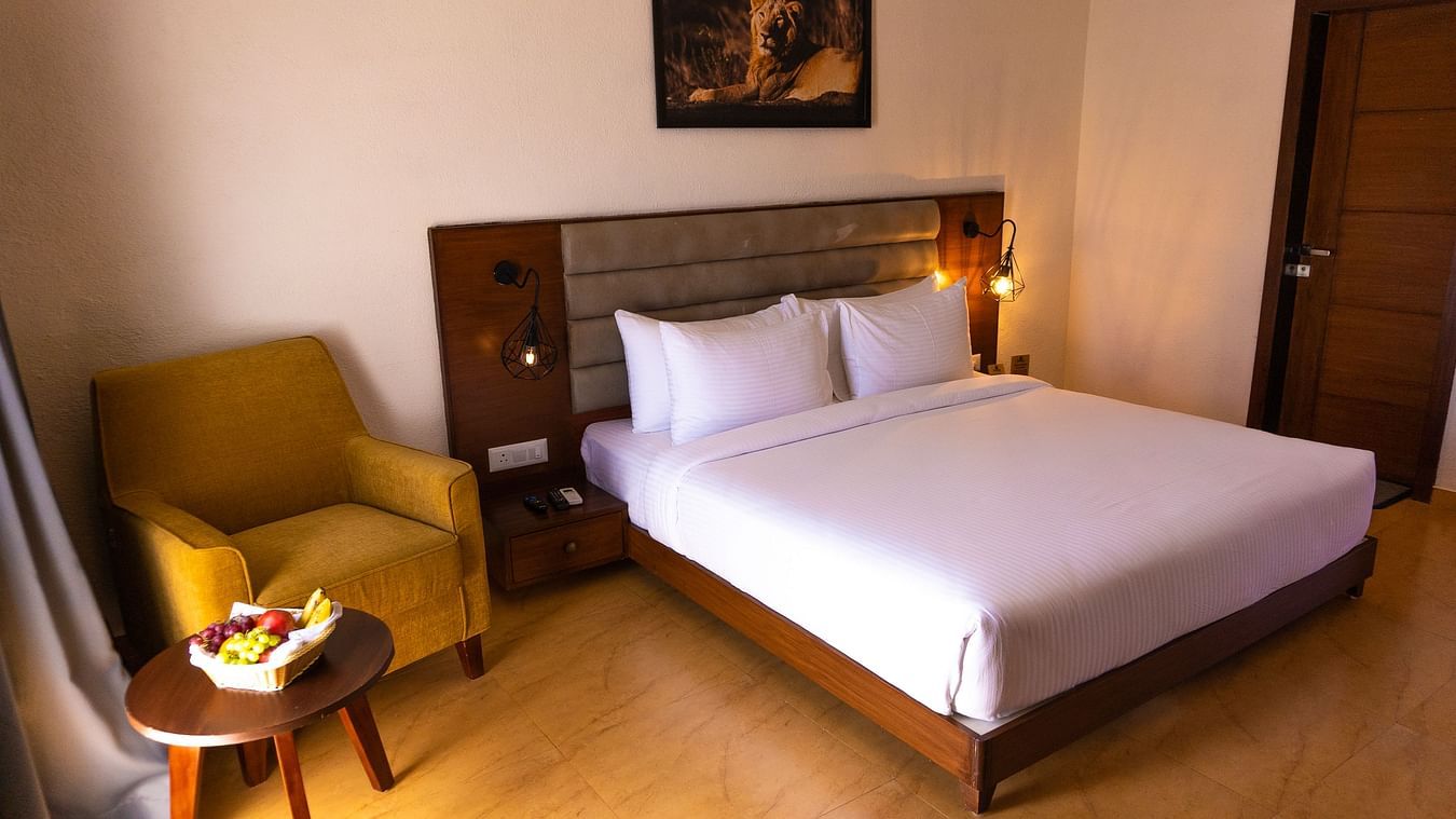 bedroom with white bed covers and other various other amenities at Jagira Ananta Elite 6