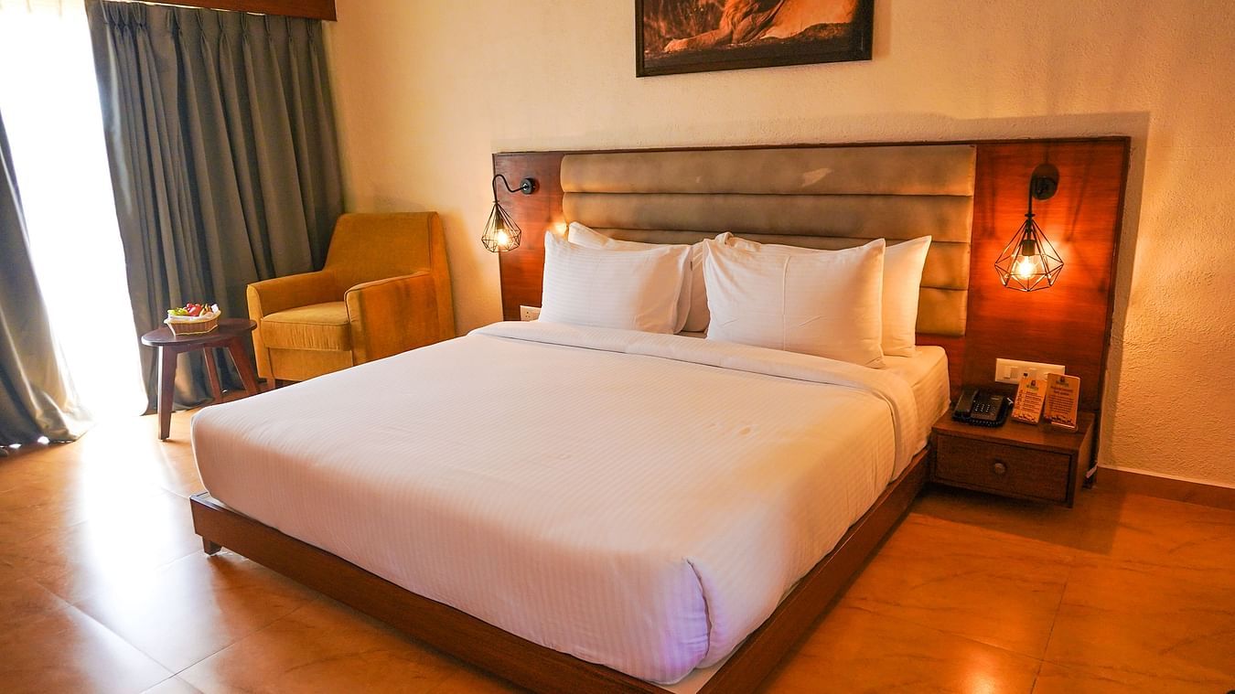 bedroom with white bed covers and other various other amenities at Jagira Ananta Elite 7