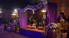 Beautifully decorated wedding setup with dim lighting and elevated surface decorated for seating - Clarks Avadh, Lucknow