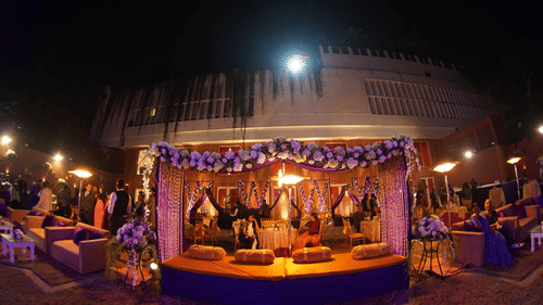 Elegant outdoor event setup at Clarks Avadh with floral decor and lighting.