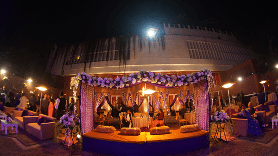 Elegant outdoor event setup at Clarks Avadh with floral decor and lighting.