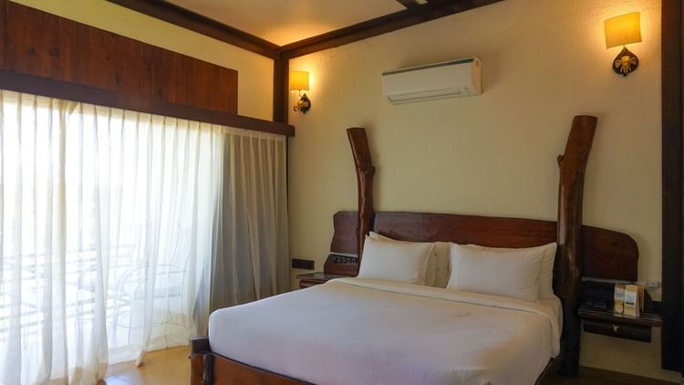 bedroom with white bed covers and other various other amenities at Jagira Ananta Elite 5