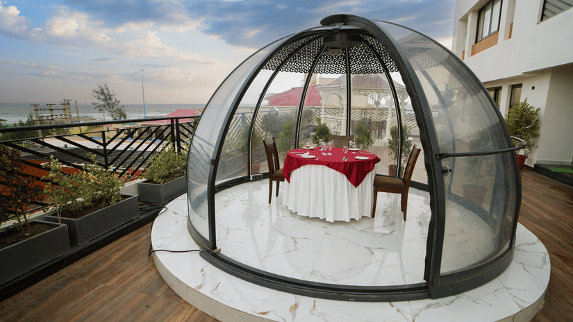 a half bubble kind of architecture with a table for two set inside it on the terrace at Shanti Seaview Resort & Spa - Hotels in Mandarmani Sea Facing