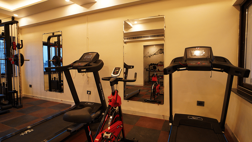 treadmills with a cycle and mirrors inside the fitness centre - Shanti Seaview Resort & Spa