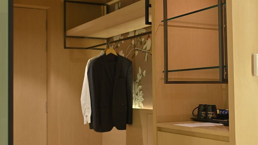 Multiple shirts neatly hanging on hangers in an open wardrobe at Clarks Collection Grand Sapphire, Ajmer.