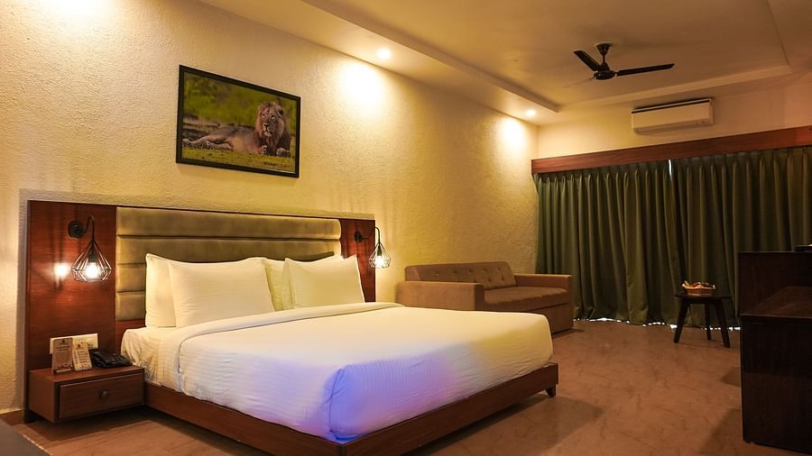 bedroom with white bed covers and other various other amenities at Jagira Ananta Elite 8