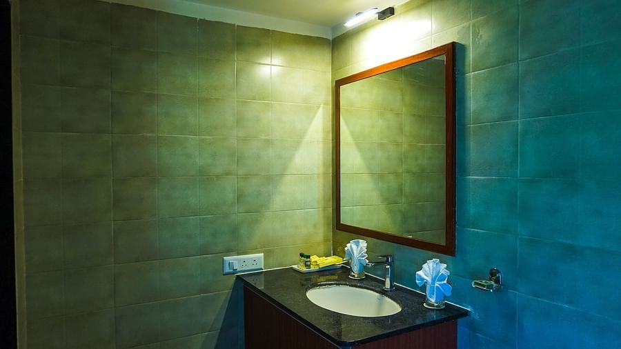 modern bathroom with dim lighting and modern amenities at Jagira Ananta Elite