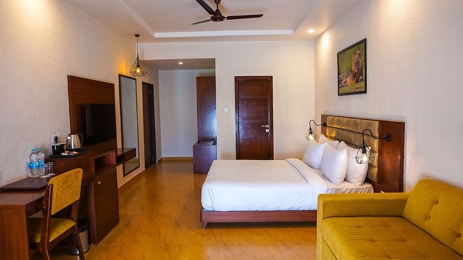 bedroom with white bed covers and other various other amenities at Jagira Ananta Elite 9