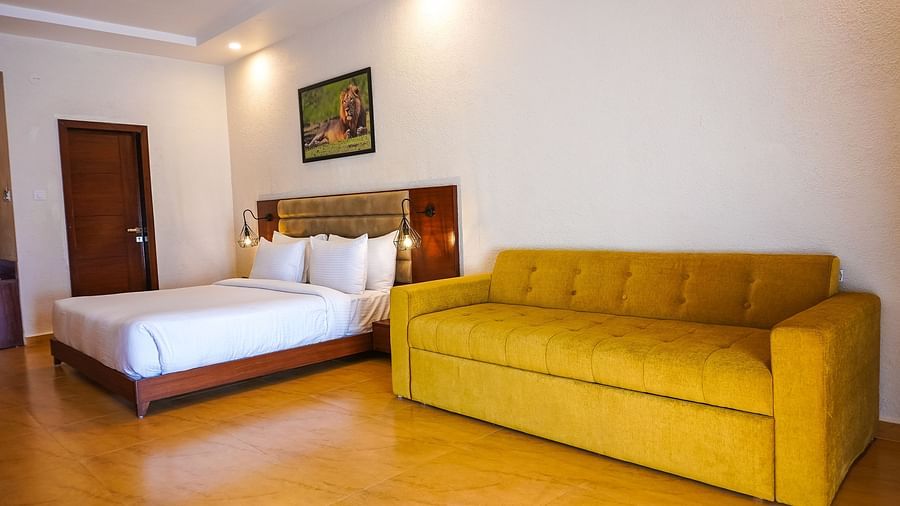 bedroom with white bed covers and other various other amenities at Jagira Ananta Elite 15