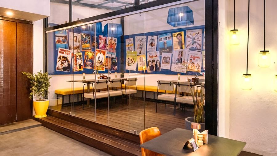 Cafe with a small room with wall paintings and comfy seating at Marasa Sarovar Portico, Rajkot