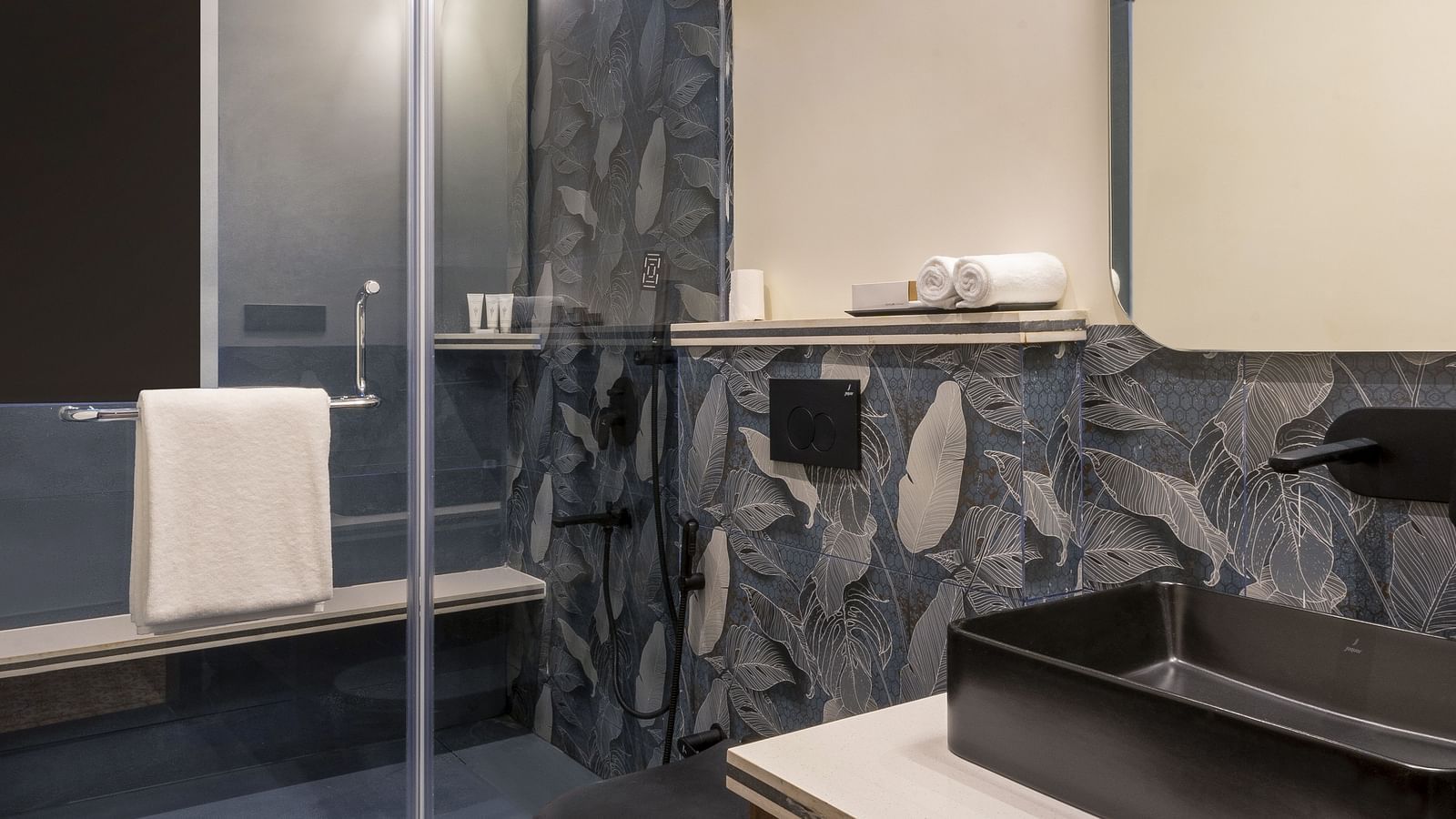 An overview of a bathroom with sink area in view in one of the rooms - The Tanisi Hotels & Resorts, Goa
