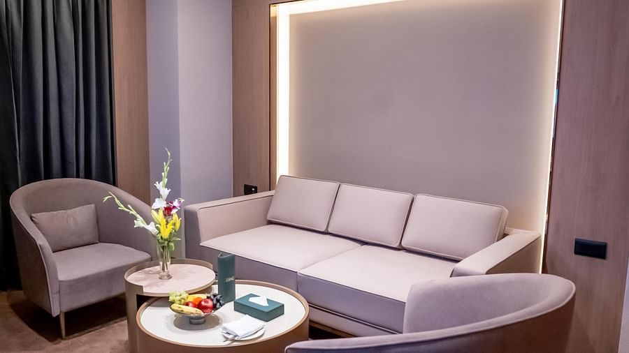 Living area with sofa, chairs and a window with a curtain in the background at ASTER GRAND BY ZENQ SAKET.