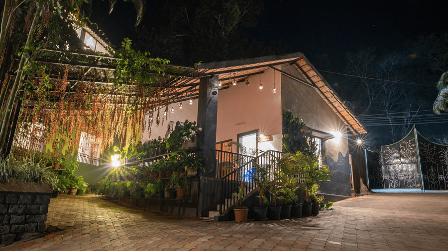 Night facade of an accommodation with an open area in front at Coorg Jungle Camp.