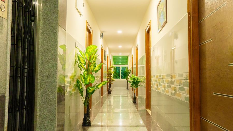 An image of a corridor with plants - Hotel Aerotel, Hyderabad - A Unit of Comfort Hometel