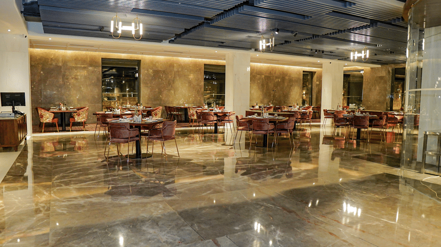 The stylishly appointed, low-lit restaurant with comfortable velvet chairs and marble walls at Pushkara Resort & Spa.