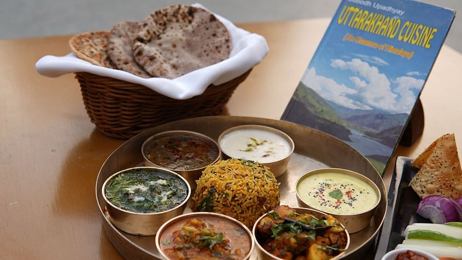 Kumaoni Thali being served in a restaurant on a wooden table at Saraca Resort & Spa Corbett