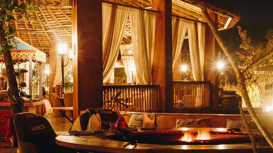 Night view of village lounge dining area at Surpura Bagh.