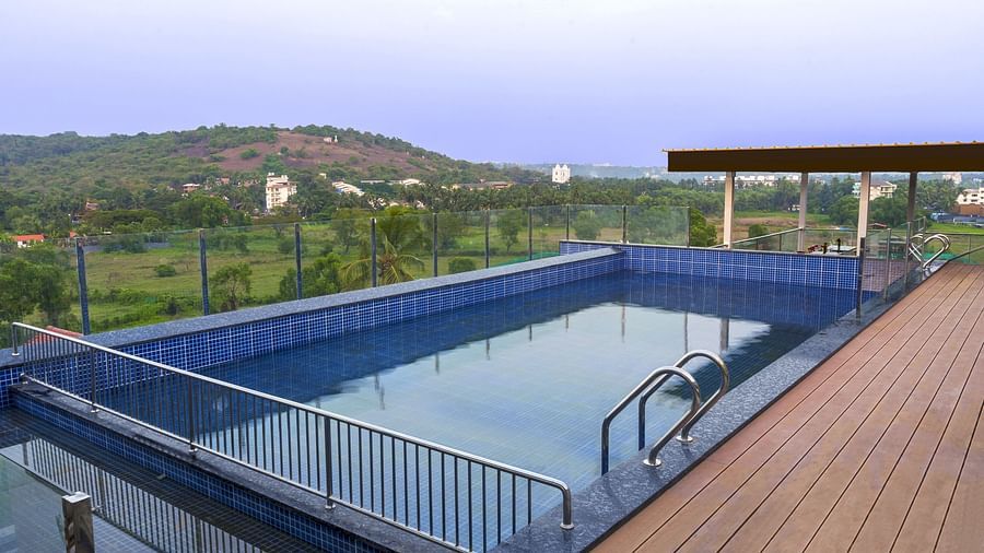 Overview of the swimming pool with a walking deck next to it - The Tanisi Hotels & Resorts, Goa