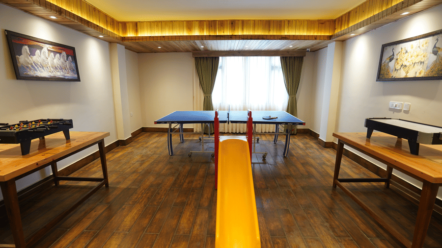 Indoor games room at Valmere Magnolia Boutique Hotel & Spa, Pelling with a table tennis table, foosball table, air hockey table, and framed wall artwork.