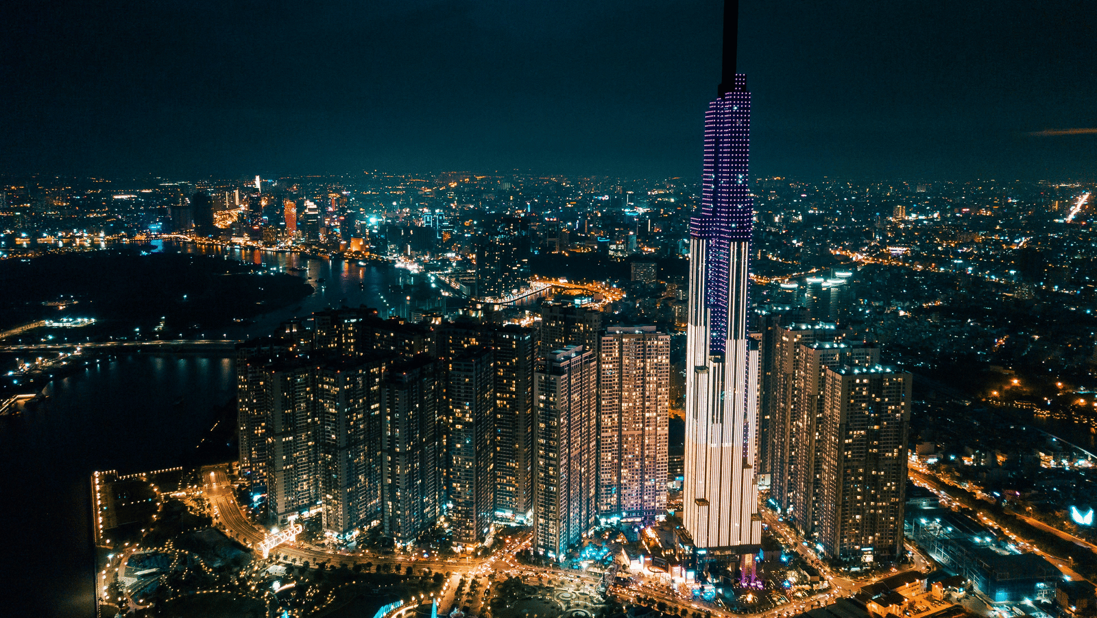 A drone view of Ho Chi Minh City, one of the best Places to Visit in South Vietnam, during the night with the lights on.