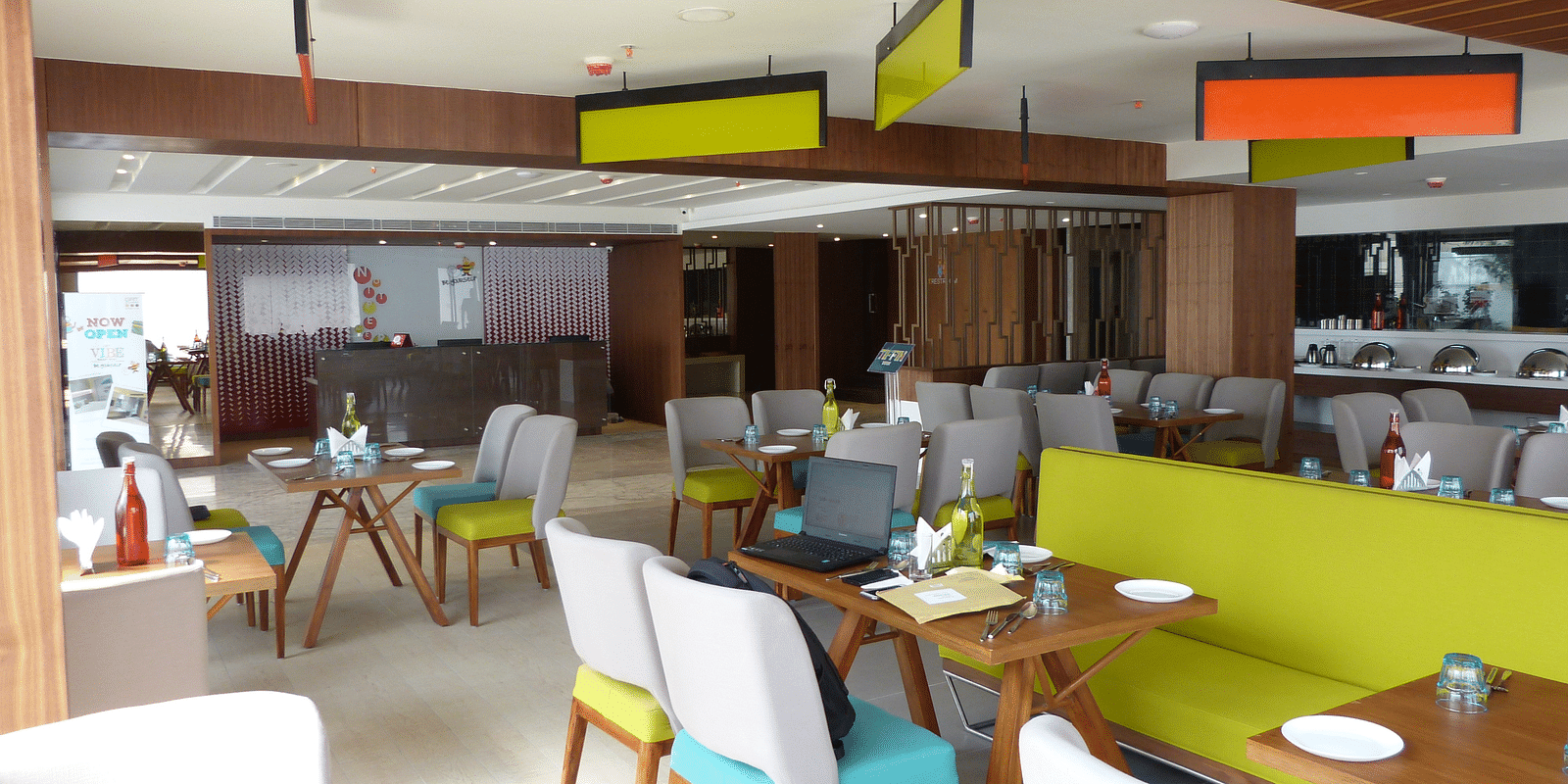 The dining area is set up with tables and chairs arranged neatly for the guests