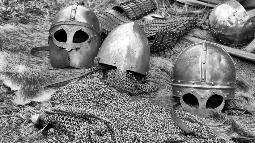 A black and white image showing the helmets and chain mail armor used in a battle