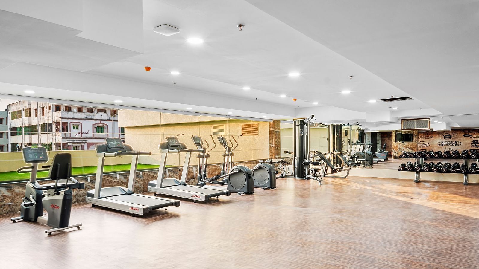 A view of the fitness centre with treading mills placed next to each other at Grand Vijayawada by GRT Hotels.