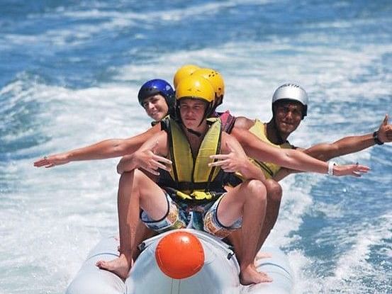 banana boat, people on boat, sea.