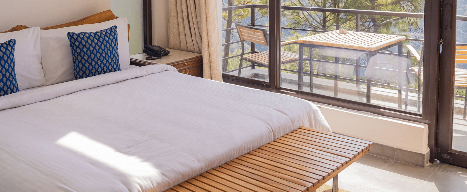 A bedroom featuring balcony at BluSalzz Escapade Resort, Lansdowne