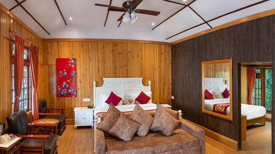 A room at Summit Barsana Resort & Spa, Kalimpong with a double bed 