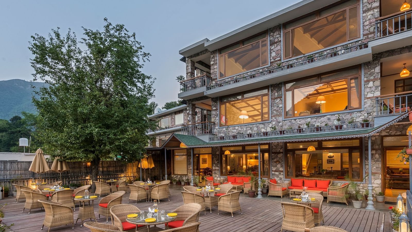 Outdoor restaurant at Fishermen's Lodge, Bhimtal, featuring a beautiful view, creating a perfect setting for dining in nature.
