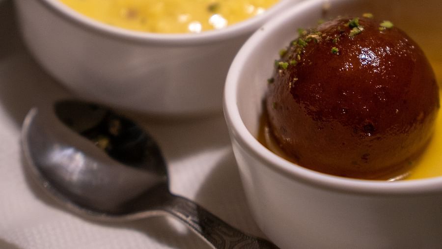 fruit custard and gulab jamun served in ice-cream bowls at a restaurant - Barsana Boutique Hotel Kolkata