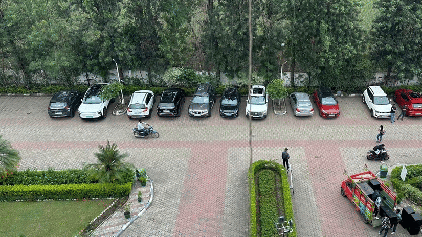 Aerial view of the parking area with vehicles parked in line at Amer Greens, Bhopal