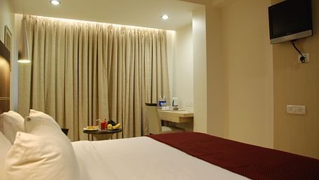 Image of a room with a large bed and television at The Oriental Residency