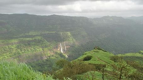 A scenic view of the hills featuring lush green mountains under a cloudy sky. - Navi Mumbai weekend getaways