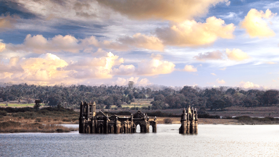 A far-out view of Shettihalli Church submerged inside river hemavati - Hoysala Village Resort.
