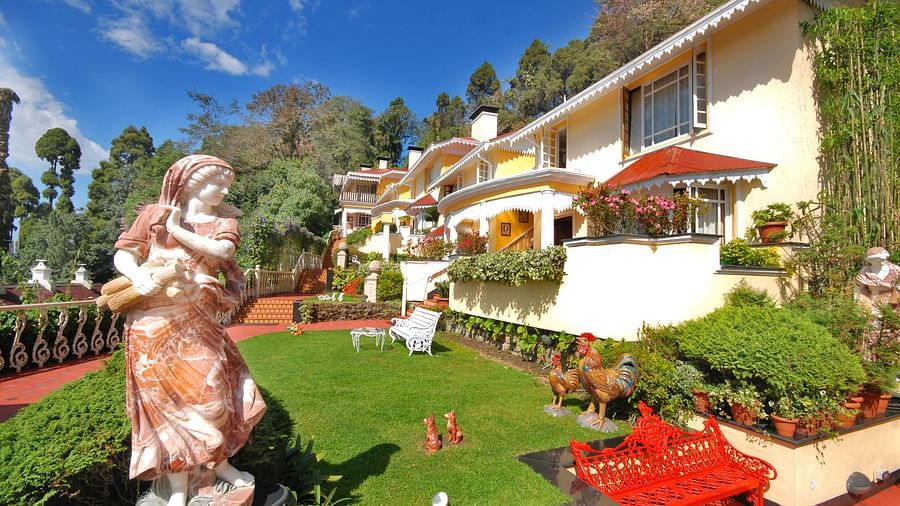 a statue in the lawn area  -Mayfair Hill Resort, Darjeeling