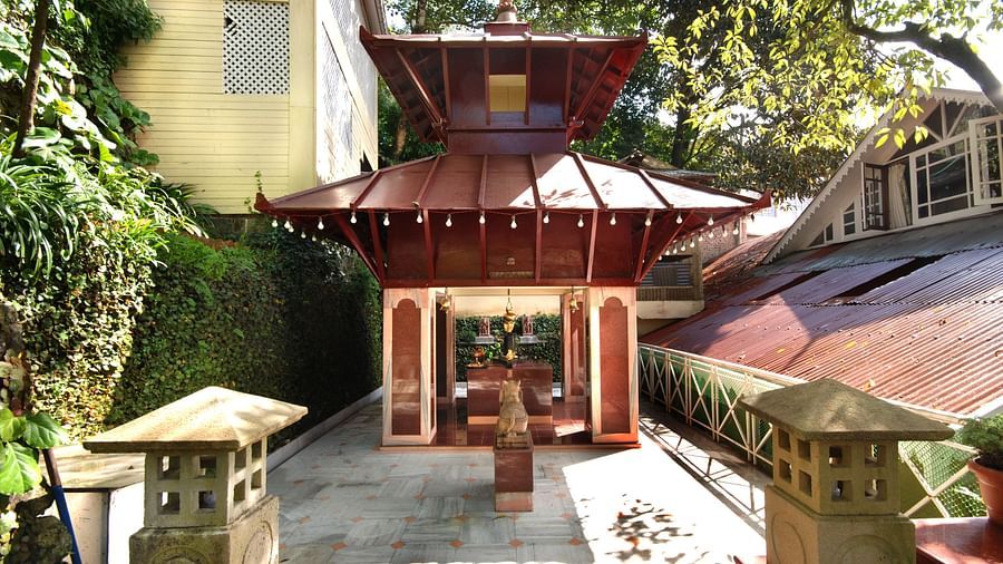 a hallway to a monastery-like architecture - Mayfair Hill Resort, Darjeeling