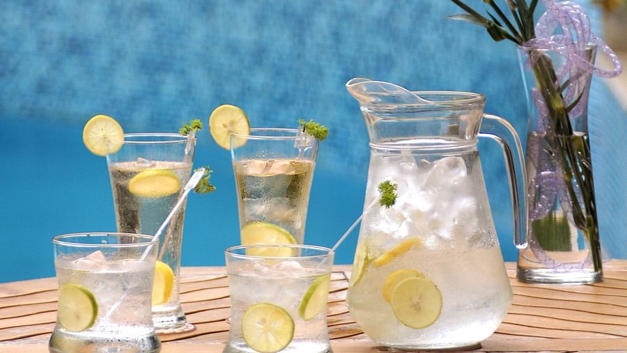 drinks and glasses in front of a swimming pool