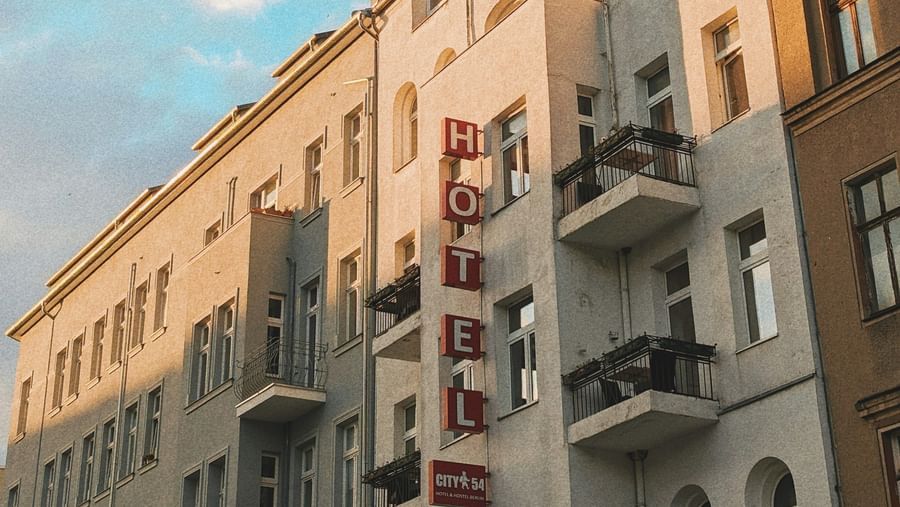  A low-angle view of a row of European-style buildings with balconies under a blue sky
