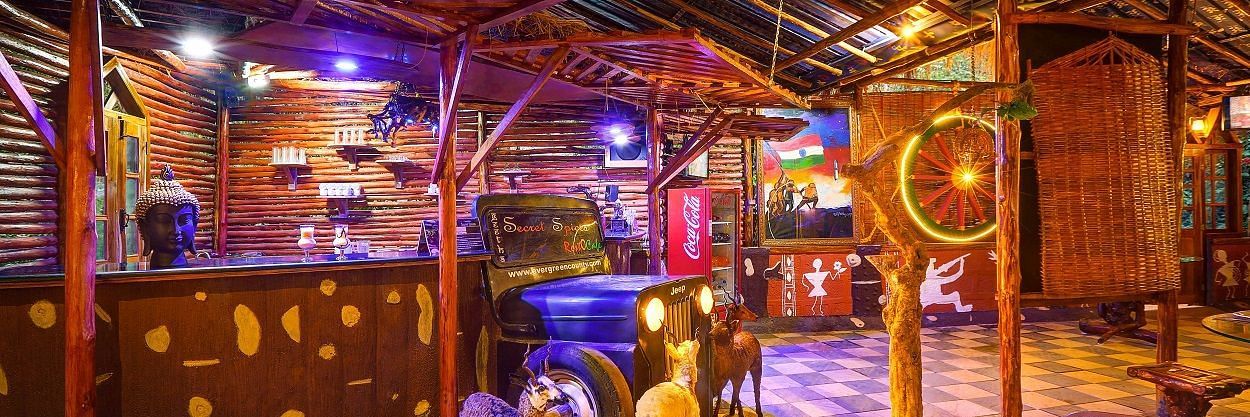 Quirky restaurant interior with vibrant lighting, vintage decor, and a jeep repurposed as a bar counter - Evergreen County
