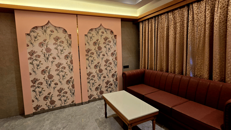 Cosy lounge area with sofa seating and decorative panels at Hotel Mumbai House, Digha, Airoli.
