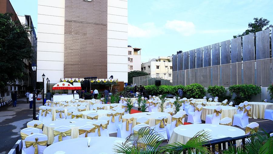 A beautiful outdoor dining setup with round tables and chairs arranged for an event - Grand Continent, Brookefield