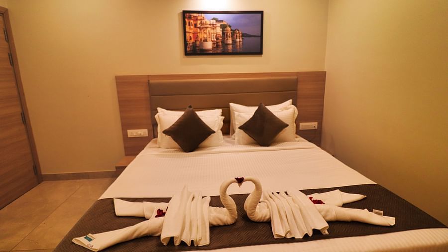 Image of Deluxe Room with the bed decorated with two towel swans.