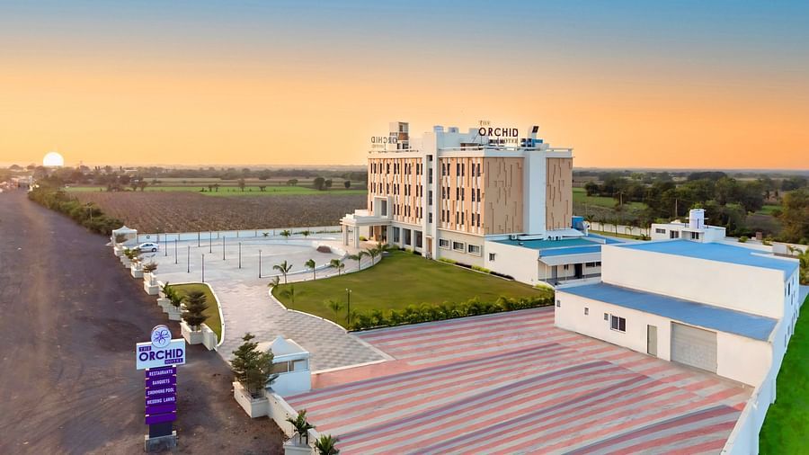 bird's eye view of The Orchid Hotel, Jamnagar with evening sky in the background